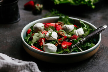 Salad with strawberries, mozzarella and arugula