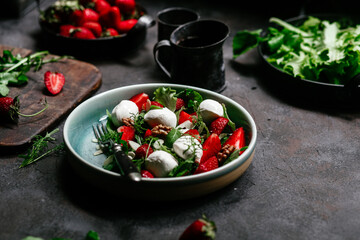 Salad with strawberries, mozzarella and arugula