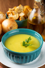 Bowl with onion soup and croutons on the table.