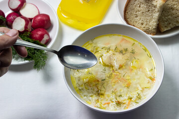 Homemade rice soup on a white tablecloth. Nutritious lunch. Healthy nutrition concept