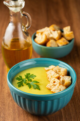 Bowl with onion soup and croutons on the table.