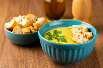 Bowl with onion soup and croutons on the table.