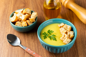 Bowl with onion soup and croutons on the table.