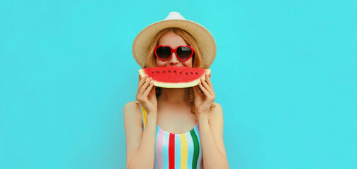 Summer portrait of happy smiling young woman with slice of watermelon wearing a hat on blue...