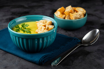 Bowl with onion soup and croutons on the table.
