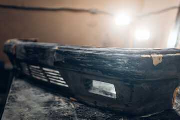 The bumper of the car is getting ready for painting. Restore and repair workshop