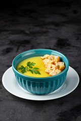 Bowl with onion soup and croutons on the table.