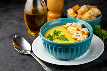 Bowl with onion soup and croutons on the table.