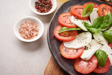 Fresh Italian salad antipasto called caprese with buffalo mozzarella, sliced tomatoes and basil with olive oil. Ingredients for vegetarian caprese salad. Italian food. top view. Rustic style.