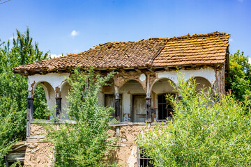 Abandoned beautiful old house with arches. Southern Bulgaria, Europe, colorful sunny spring day.
