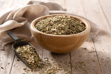 Traditional yerba mate tea in bowl on wooden table. typical Argentine drink	