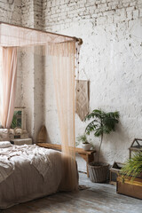 Big bed with baldachin in boho chic bedroom © brizmaker