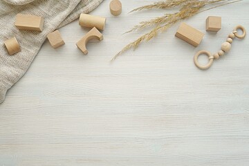 Neutral nursery, baby background, flat lay composition with natural wood building blocks, toys,...