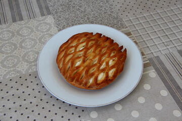 Wicker bun with cottage cheese on a plate