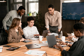 Colleagues having meeting in boardroom, working on new project