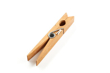 Small clothespin lies on a big clothespin on a white background