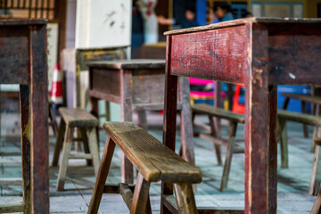 Close-up of desks and chairs in school classrooms in poor areas