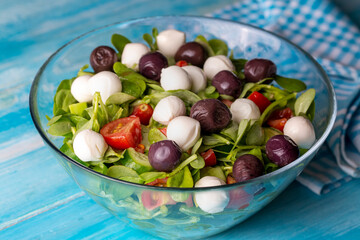 Purslane salad with cheese balls and olives inside. Healthy diet salad.
