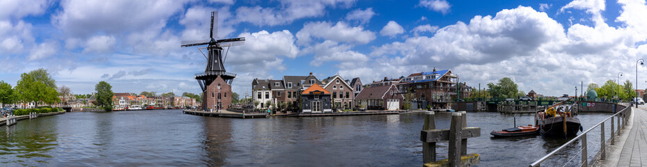 Fototapeta na wymiar panorama view of the Dee Adrian Windmill and Binnen Spaarne River in Haarlem