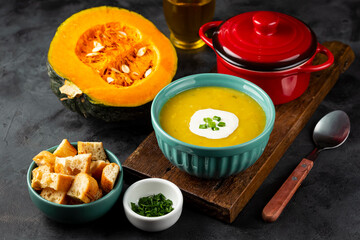Bowl with pumpkin soup on the table.