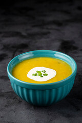 Bowl with pumpkin soup on the table.