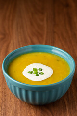 Bowl with pumpkin soup on the table.