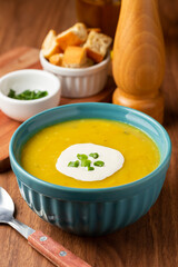 Bowl with pumpkin soup on the table.