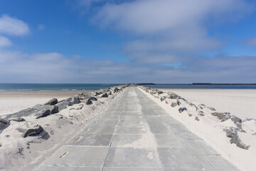 long rocky and concrete storm groin jetty to protect against erosion on the Wadden Sea coast of western Denmark