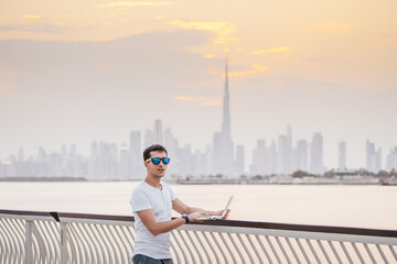 Happy man freelance programmer and junior developer writes code and thinks about a project in the...