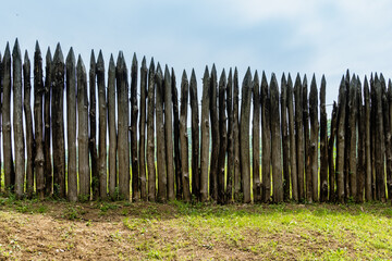 Museum complex "Mikhailovskoe fortification" with six-meter earthen ramparts in Arkhipo-Osipovka. Wooden palisade and observation towers with old cannons. Krasnodar Territory, Russia - May 16, 2021