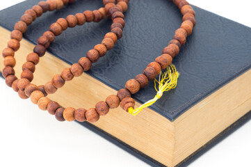Necklace with old book on white.