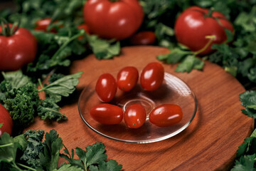 image of a plate of tomatoes on a wooden kitchen board.
