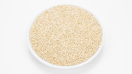 quinoa seeds in plate, white background