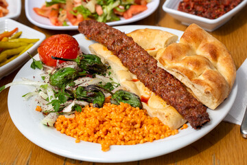 Traditional delicious Turkish food; Adana kebab while cooking on a barbecue