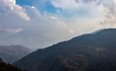 Obraz premium mountain layers with cloudy sky at morning from flat angle