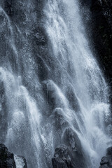 A large waterfall flows through the rocks.