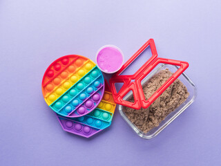 Set of colorful fidget toys to help reduce stress and anxiety in kids and adults on purple