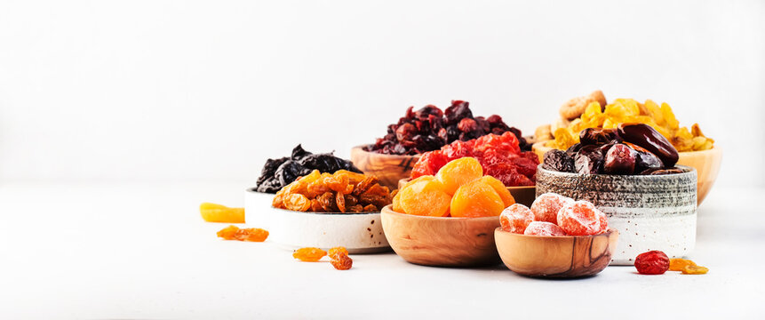 Healthy food snacks: natural dried fruits mix in bowls on white background