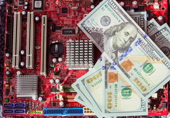 Real computer motherboard and dollar bills
