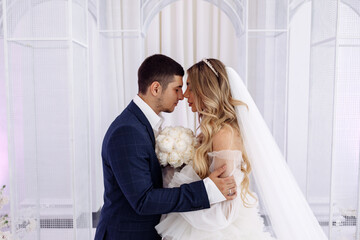 The bride and groom in the ceremony hall. The newlyweds congratulate each other. A significant day.