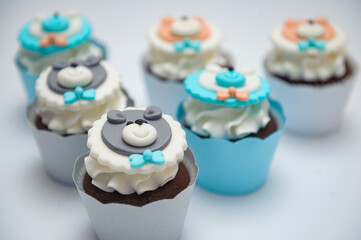 Closeup shot of chocolate cupcakes with white cream for gender reveal party