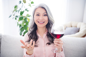 Photo of happy positive nice old woman talk conversation drink wine good mood indoors inside house home flat