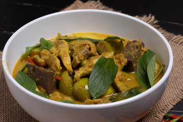 Green curry chicken on black background