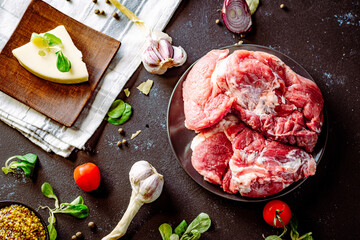 Fresh pork with vegetables on dark background. Fresh meat kitchen