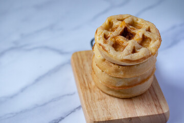 Round raisin waffles on white background