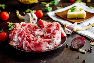 Fresh pork with vegetables on dark background. Fresh meat kitchen