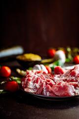 Fresh pork with vegetables on dark background. Fresh meat kitchen