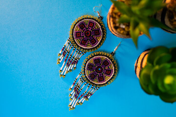 Earrings and crafts on a colorful background