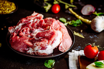Fresh pork with vegetables on dark background. Fresh meat kitchen