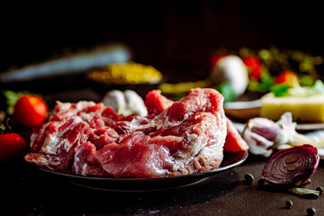 Fresh pork with vegetables on dark background. Fresh meat kitchen